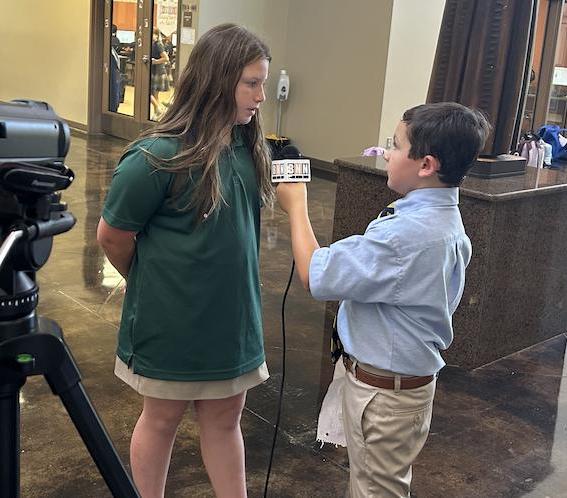 Seventh-grader Owen Holcomb interviews a St. Anthony student for JV BNN.