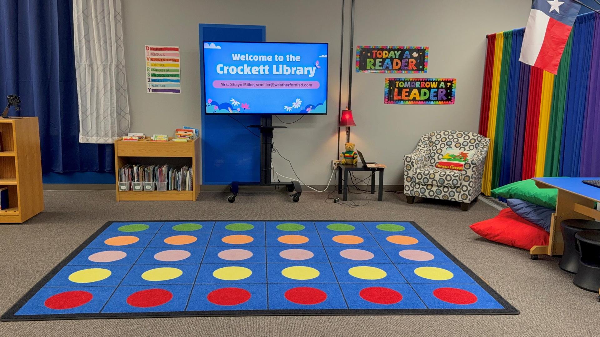This is a photograph of a brightly colored library carpet area.