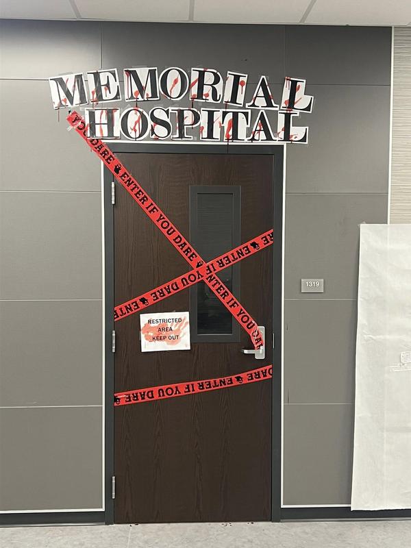 decorated door that says memorial hospital with red tape