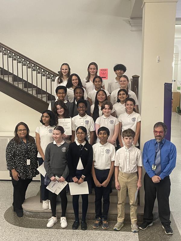 Photo of the 14 NJHS inductees with advisors on main staircase