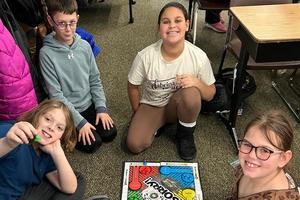 Matthew Miller, Aidan Simak, Madison Laird, and Aubrey Walker play “Sorry!” during recess
