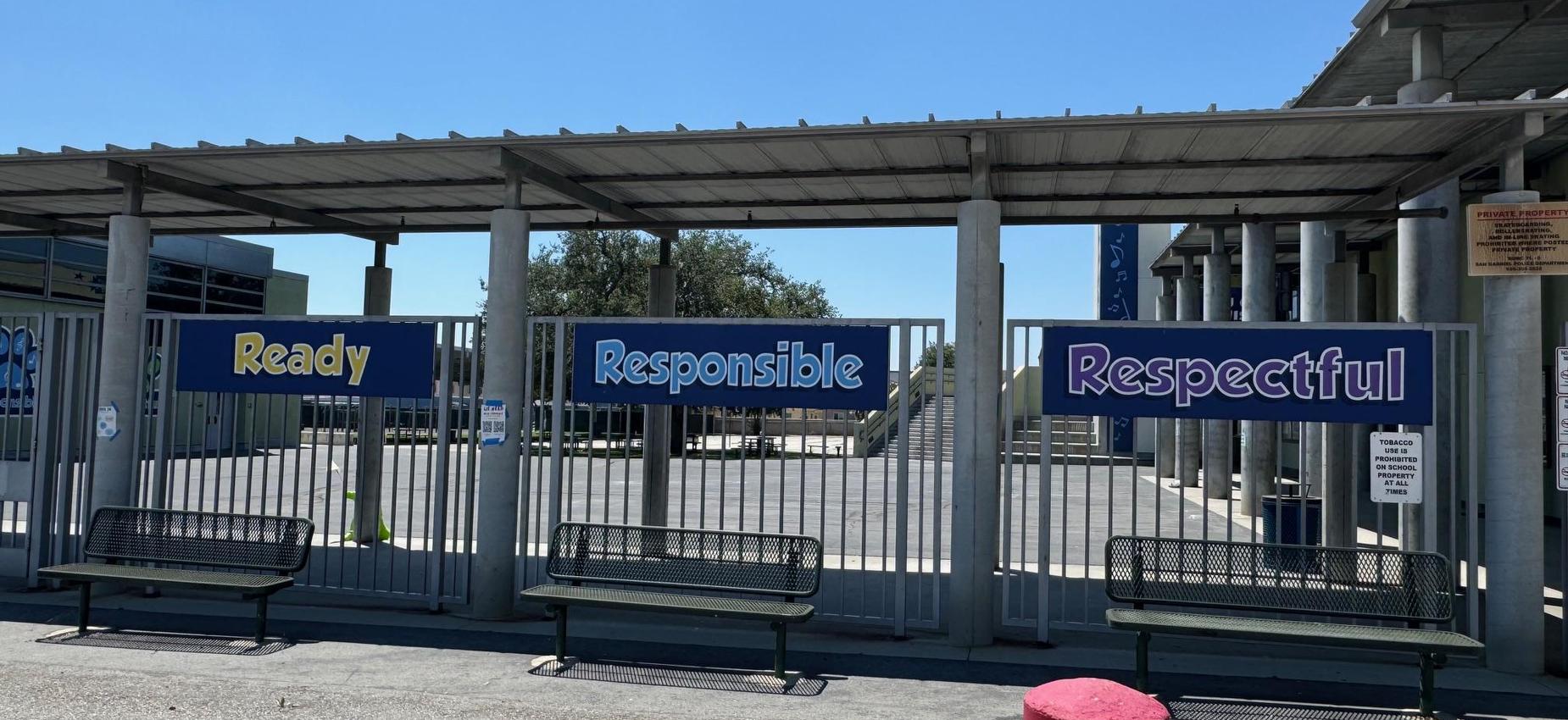 Gate displaying signs for Ready, Responsible, and Respectful behavior.