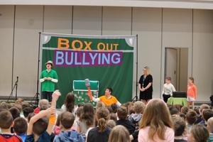 two actors on stage with a teacher and 2 students