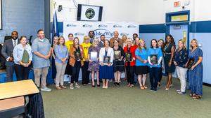 Beta sponsors and school principals being recognized for the District of Distinction at September School Board Meeting.