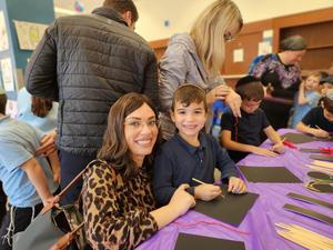 A student poses with his mother.