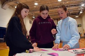 three girls putting together a puzzle