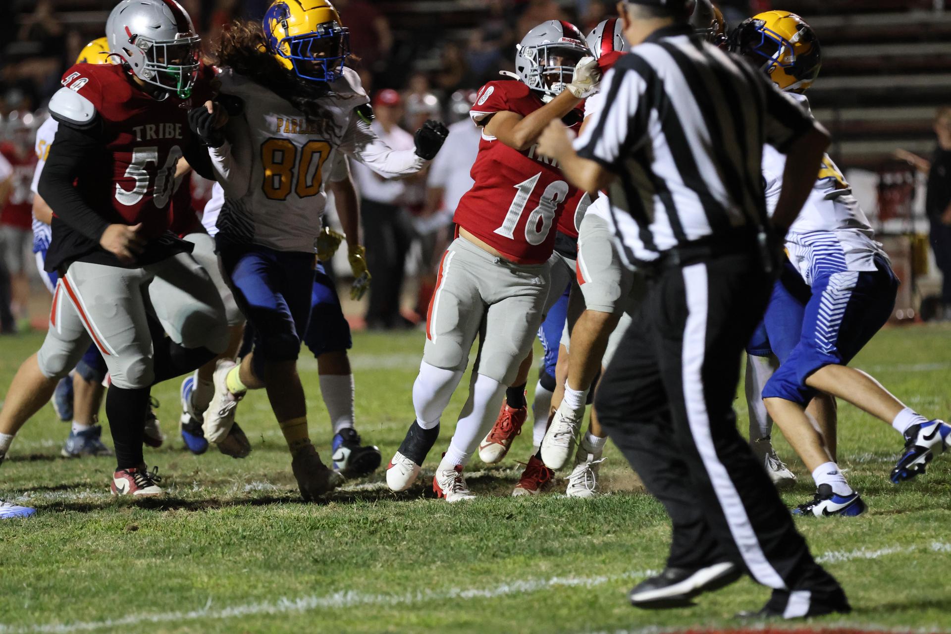 Varsity football players in action against Parlier 118