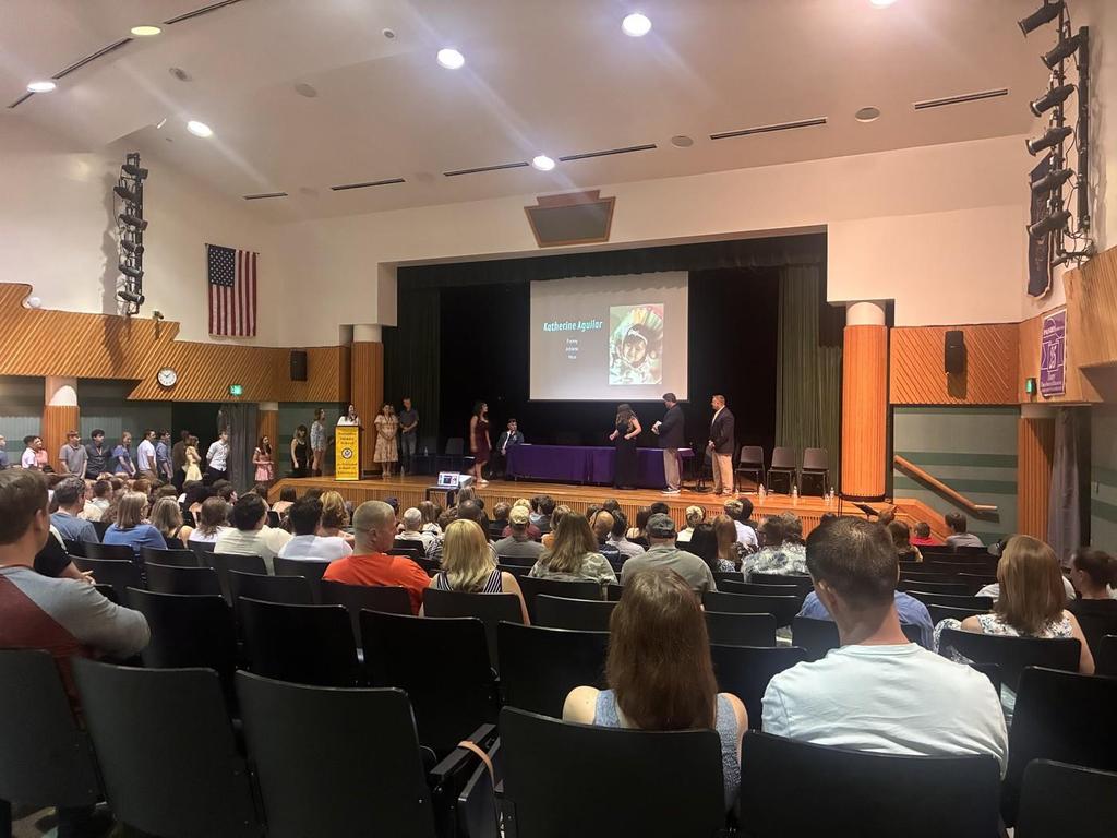 Students in the auditorium at an award ceremony.