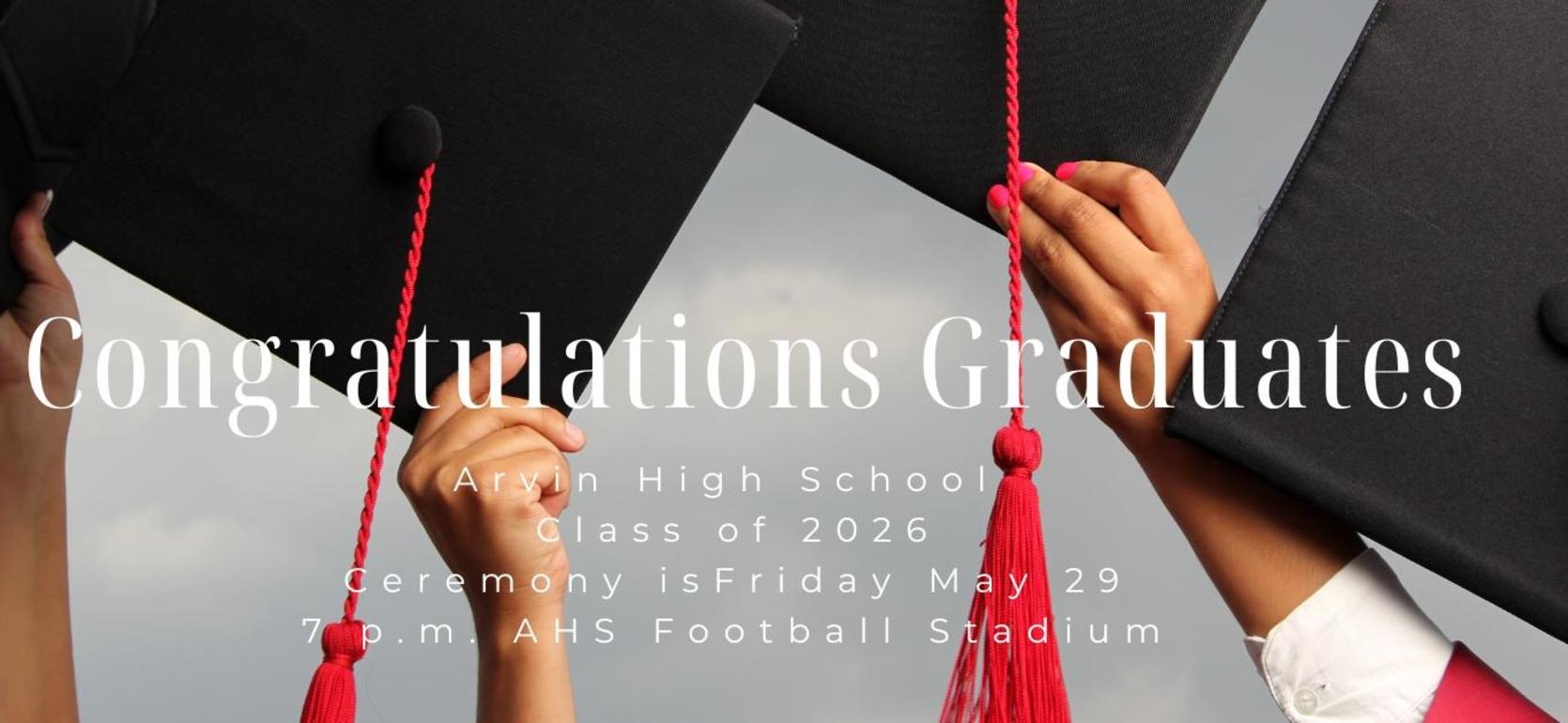 Graduates holding caps with a congratulatory message for the class of 2026.