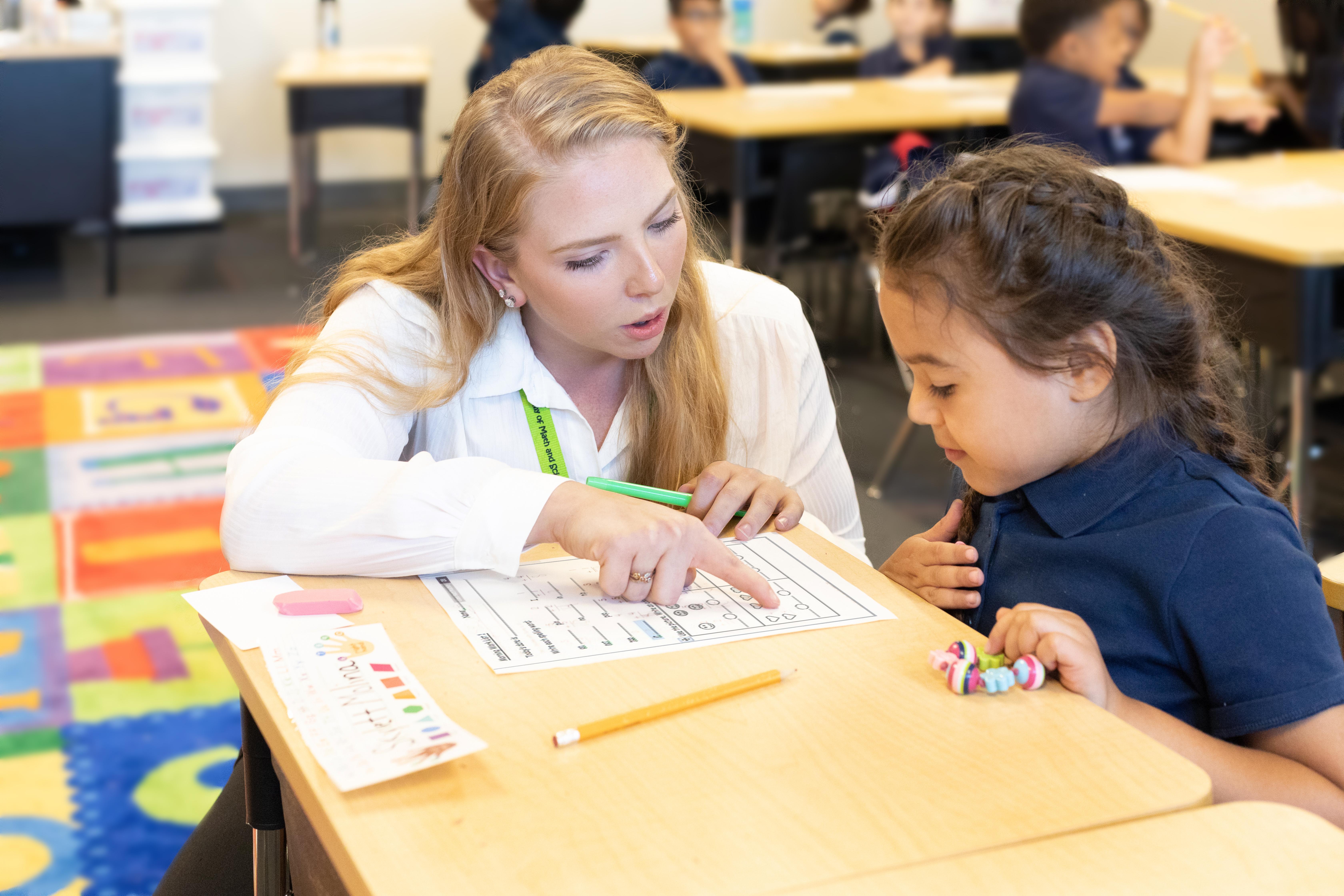 Teacher helping student image
