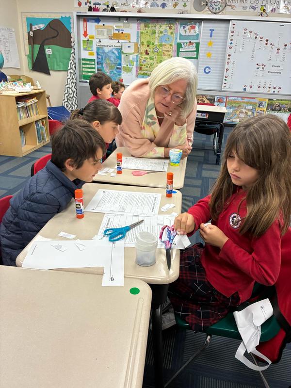 2nd grade teacher working with two students