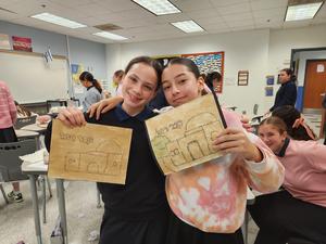 Two students pose with their completed projects.
