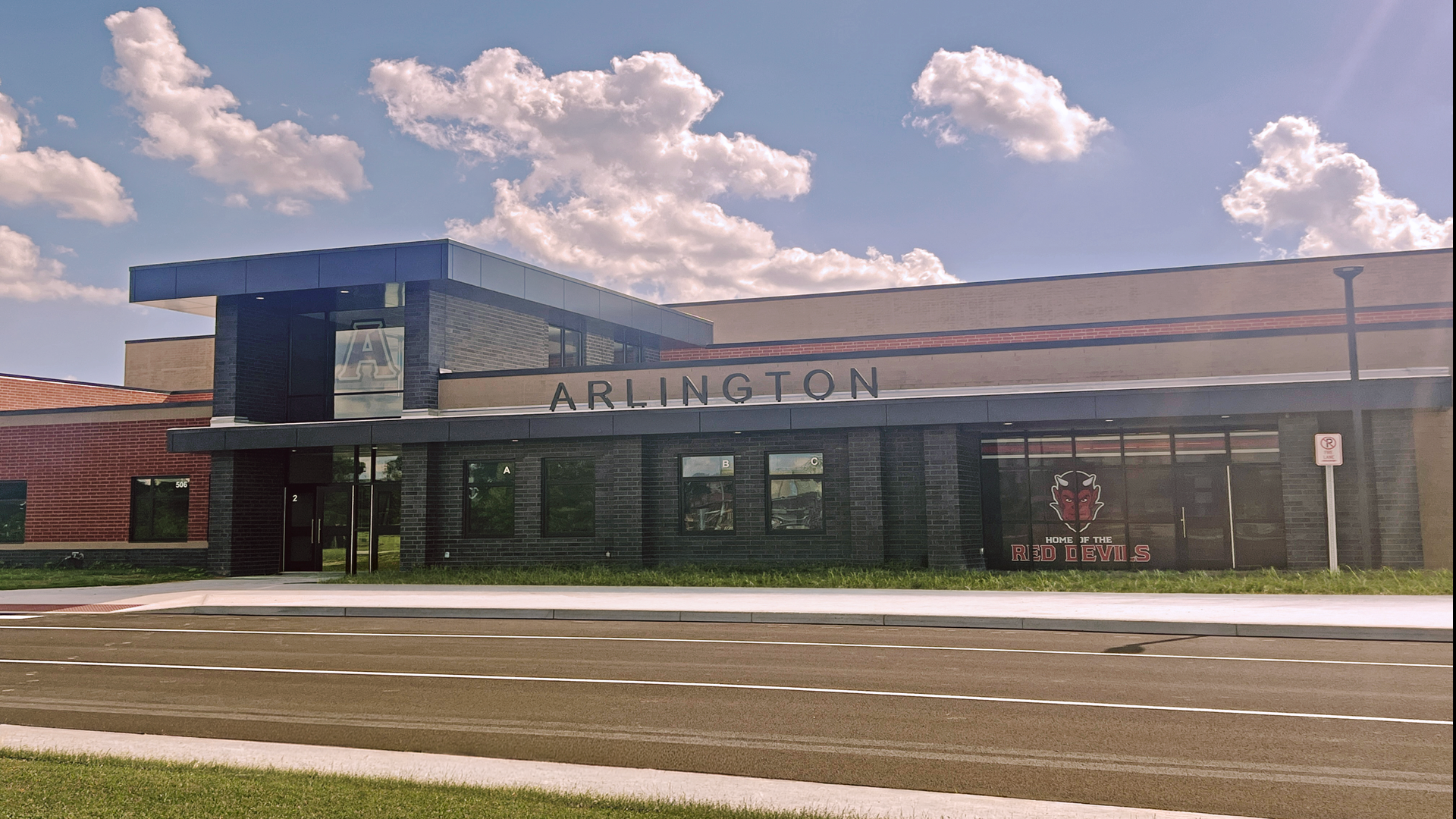 Building exterior featuring the word 'Arlington' and a school emblem.