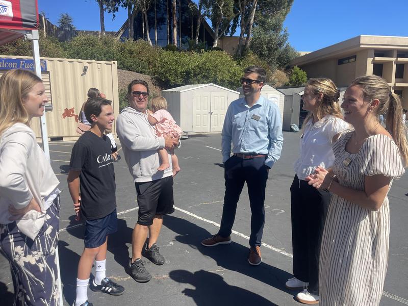 teachers greeting new student and his parents