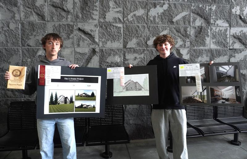 Two students show their state MITES projects.