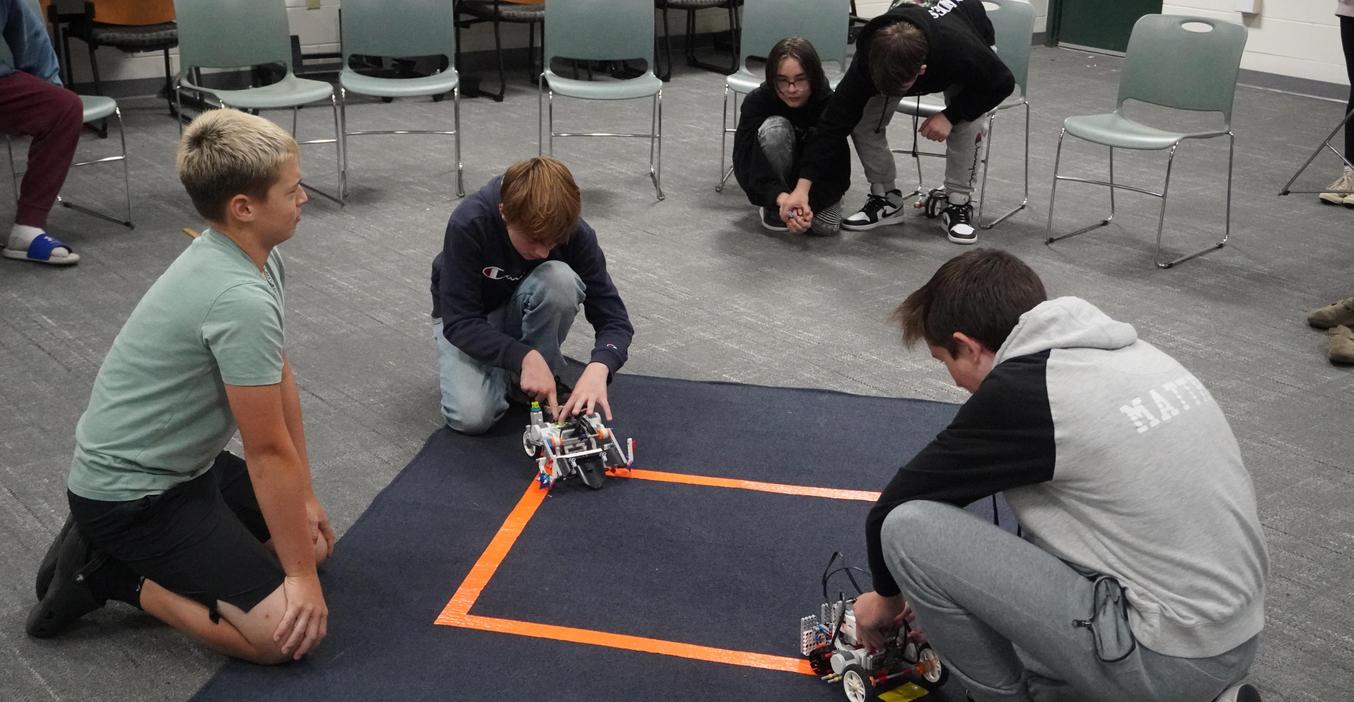 Students battle their robots as a final project.