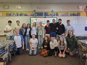 students dressed in 60s clothing smiling at camera