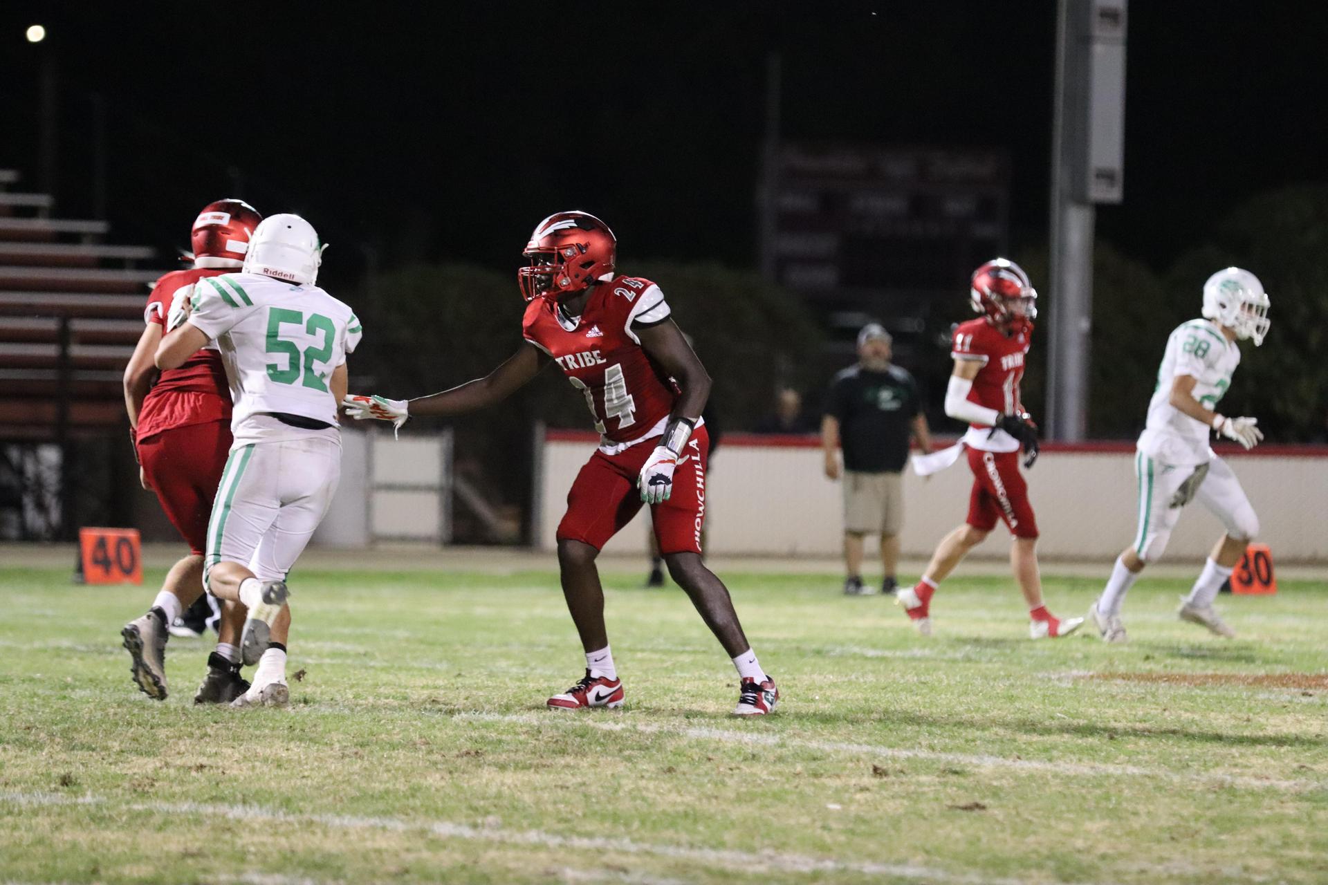 varsity football players in action against Riverdale