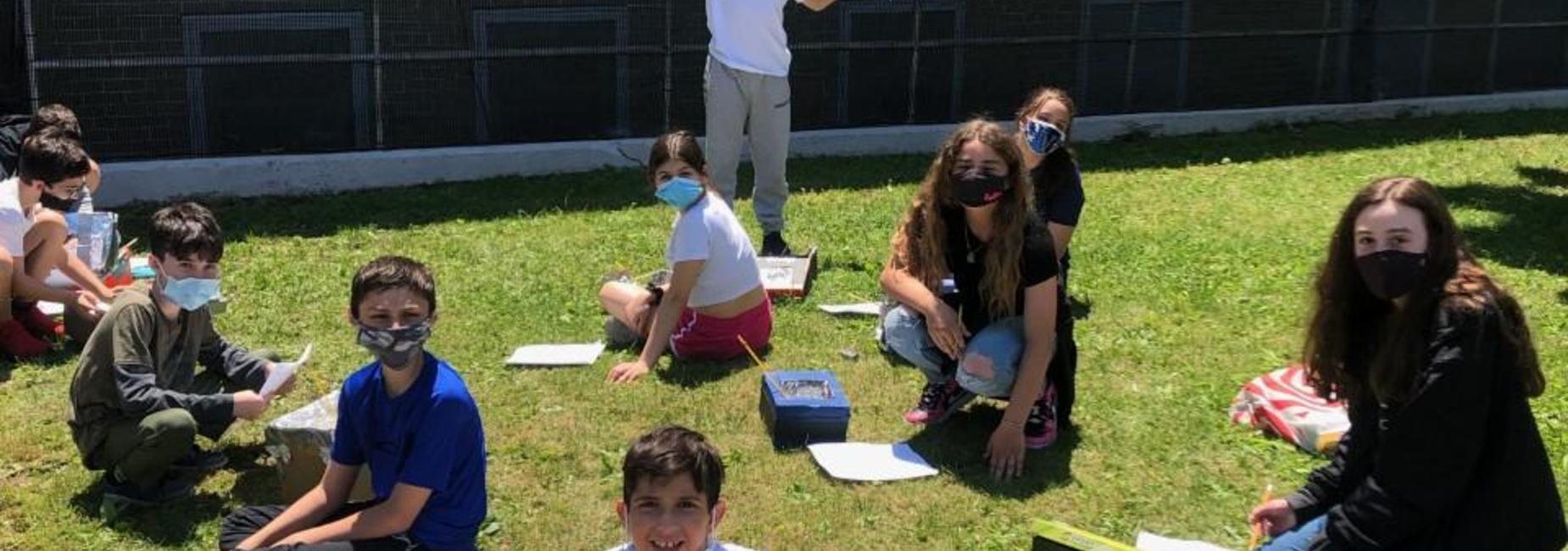 Students learning on the lawn at IS 7