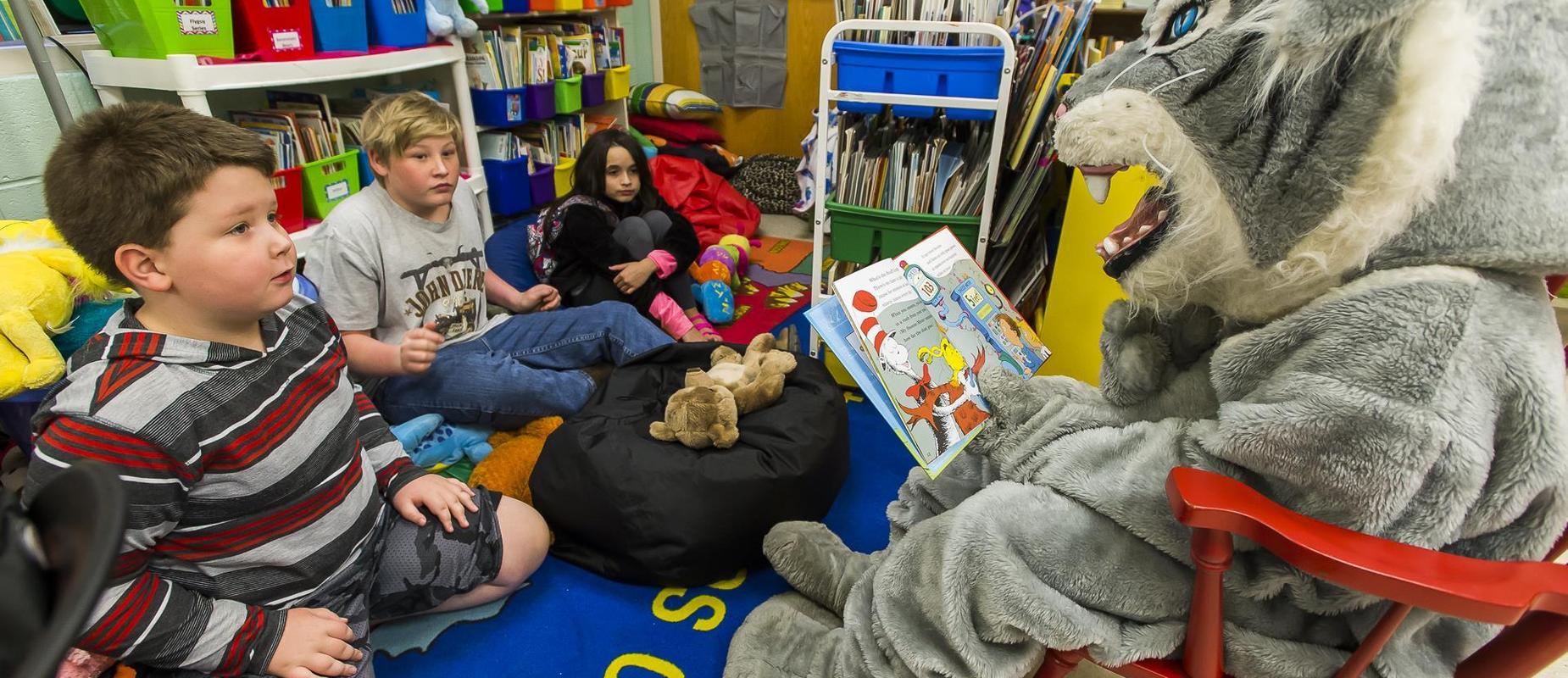 Wildcat reading to student