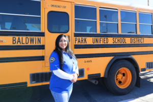 2026 Photo of Bus Driver Suzette Sendejas standing by her bus.