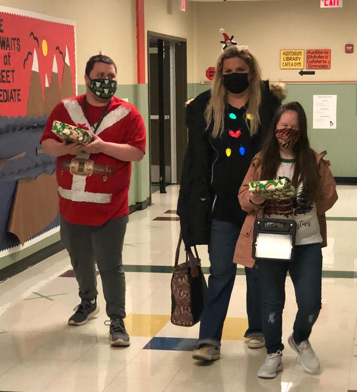 Students deliver Christmas presents to Main Street Intermediate campus.