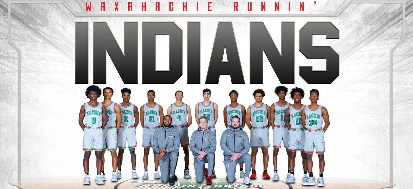 boys varsity basketball in uniform posing together with their coaches