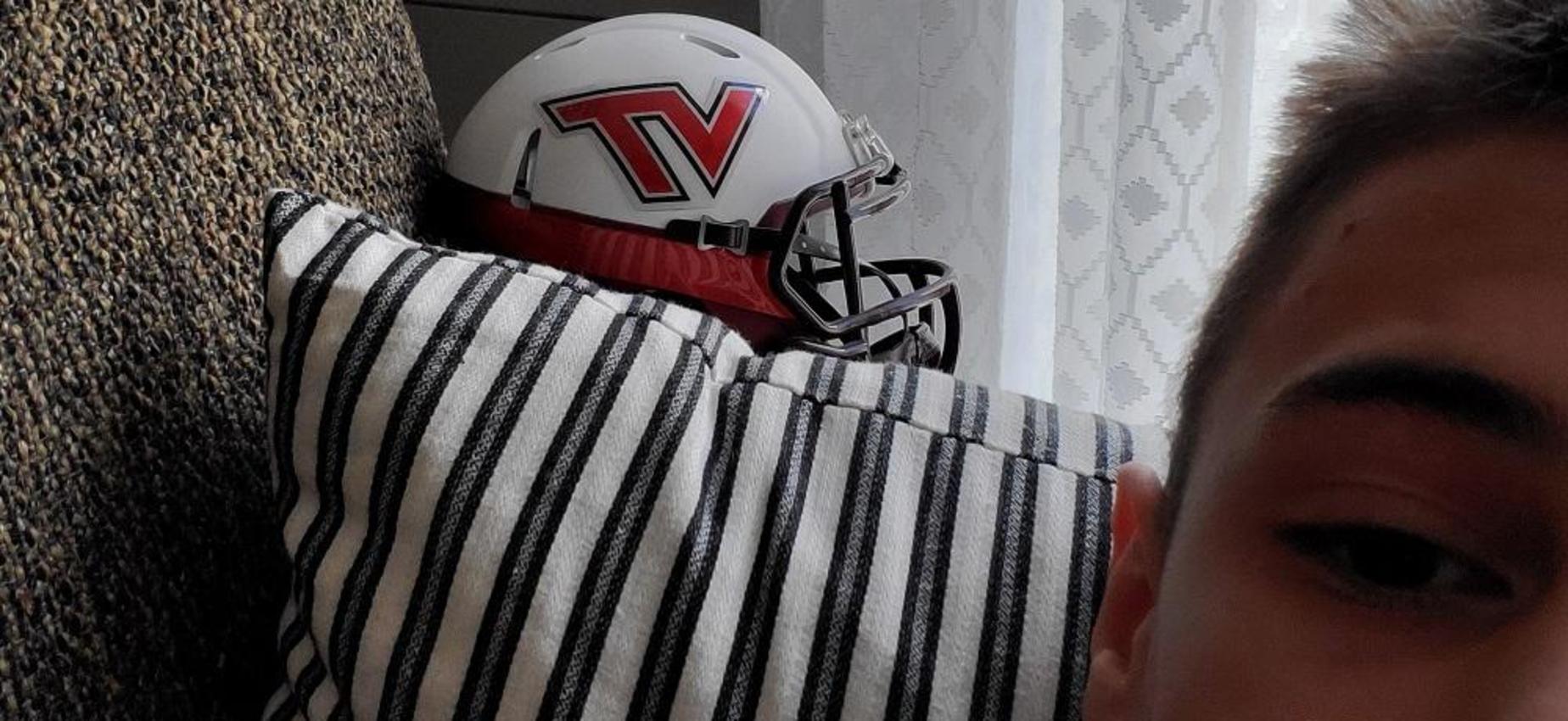 A student poses with a VT helmet.