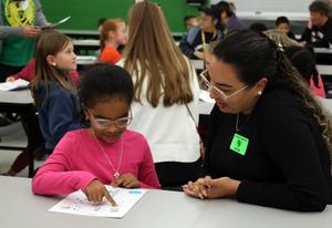 Buchanan Elementary students share writing with adults.