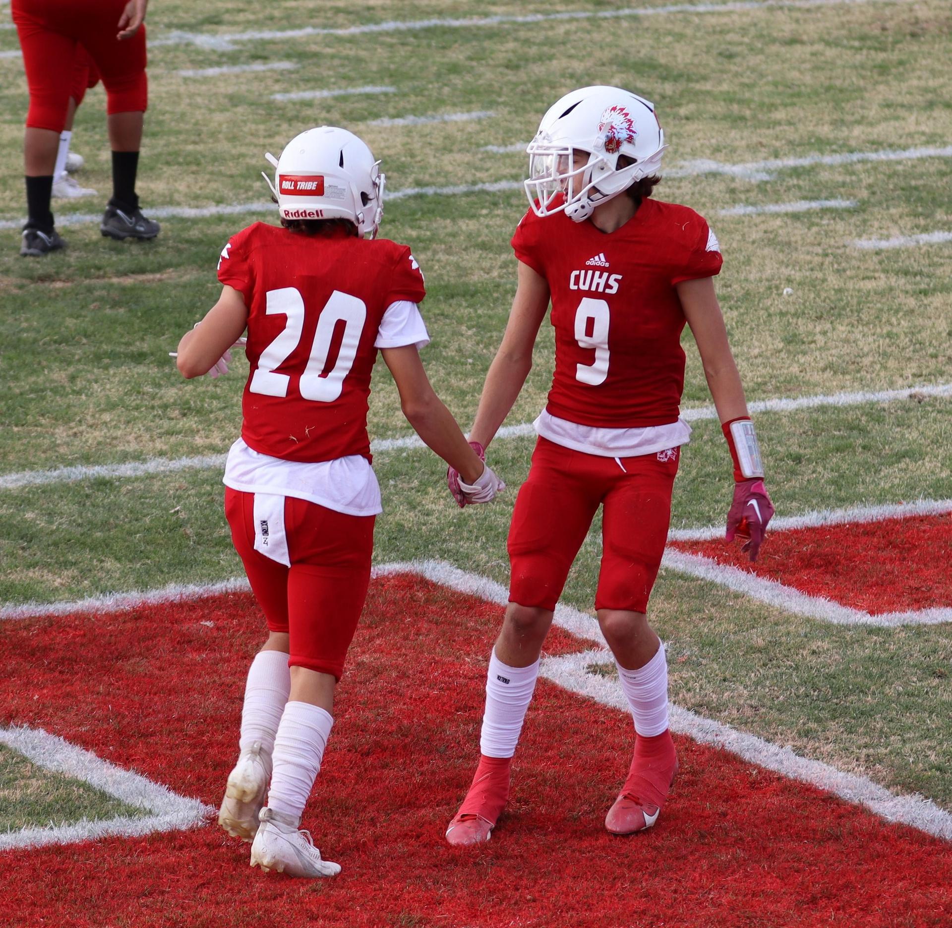  junior varsity football players in action against riverdale