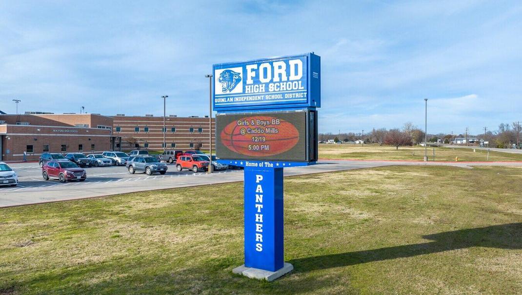 Sign for Ford High School displaying event times and school name.