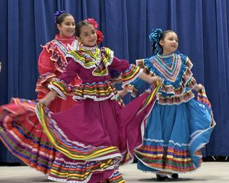 3 girls in colorful folklorico dresses
