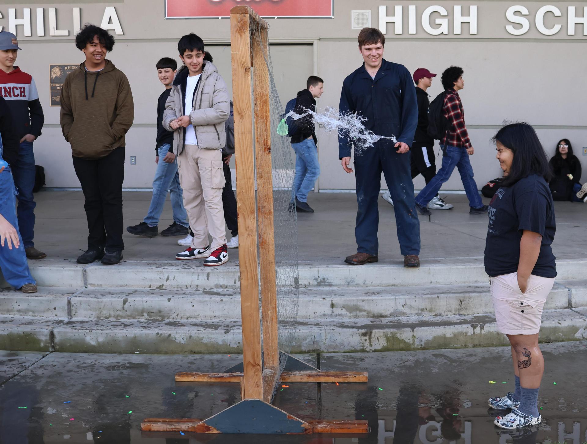 students and staff enjoying the water balloon toss