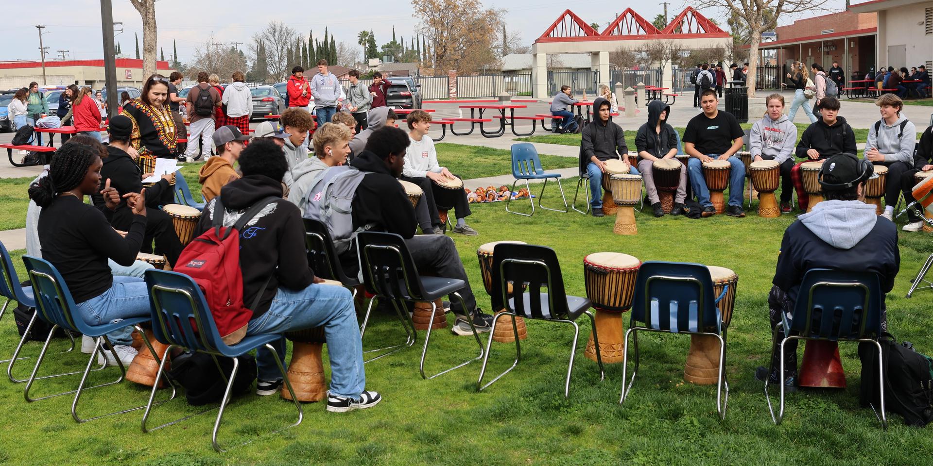 students and staff participating with the African Drum Interactive
