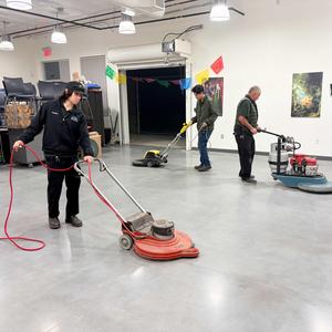 Custodians polishing floors