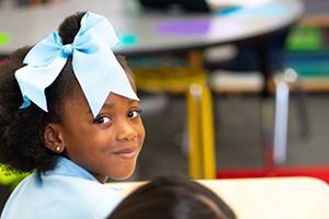Smiling student sitting at desk