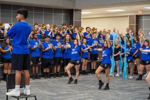 An action shot of the band performing the fight song during the ceremony.