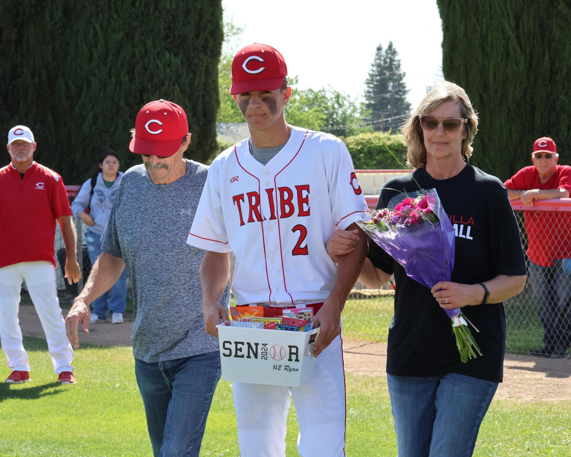 Seniors Posing With Teammates, Coaches, And Family