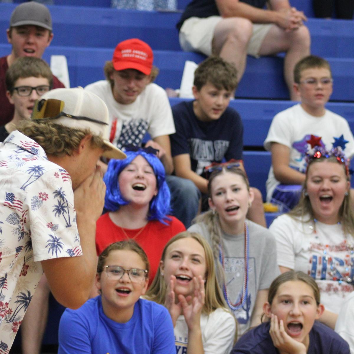 Student body cheering at volleyball game