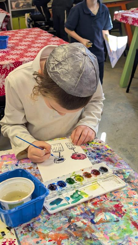 First grade boys work on watercolor vases