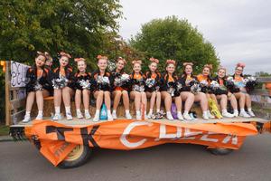 Cheerleaders gather on a float before the parade starts.