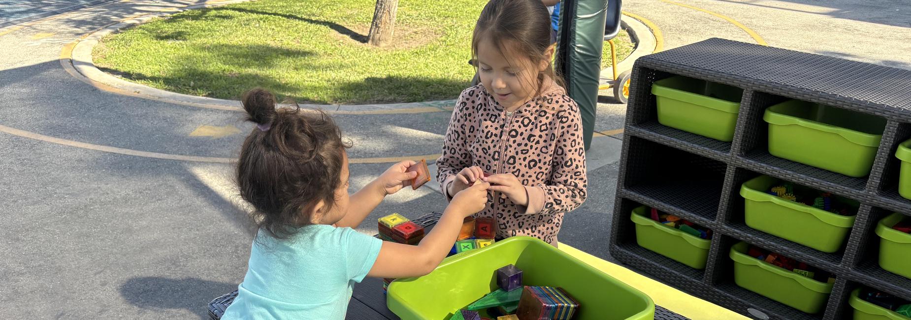 girls playing with magnetic tiles