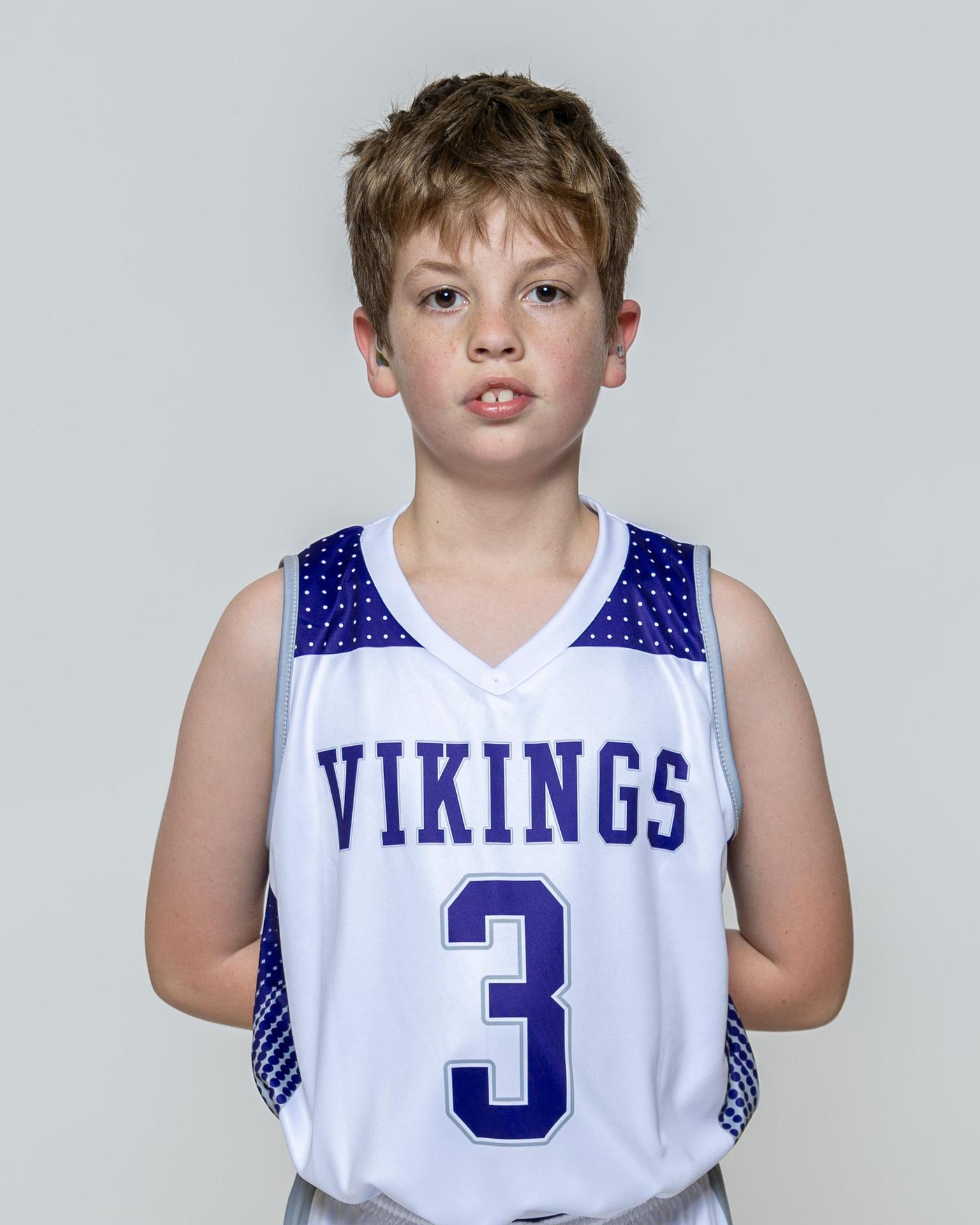 Male player number 3 posing with serious stature for a picture