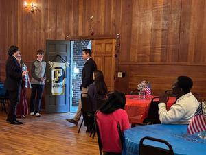 Student Council members welcoming people as they enter.