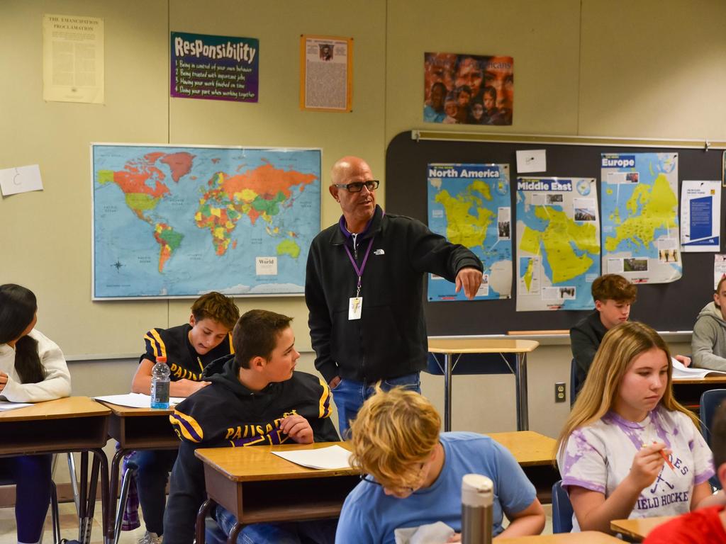Mr. Gluck instructing students in the classroom.