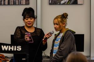 A student works with Erin Entrada Kelly to answer a trivia question