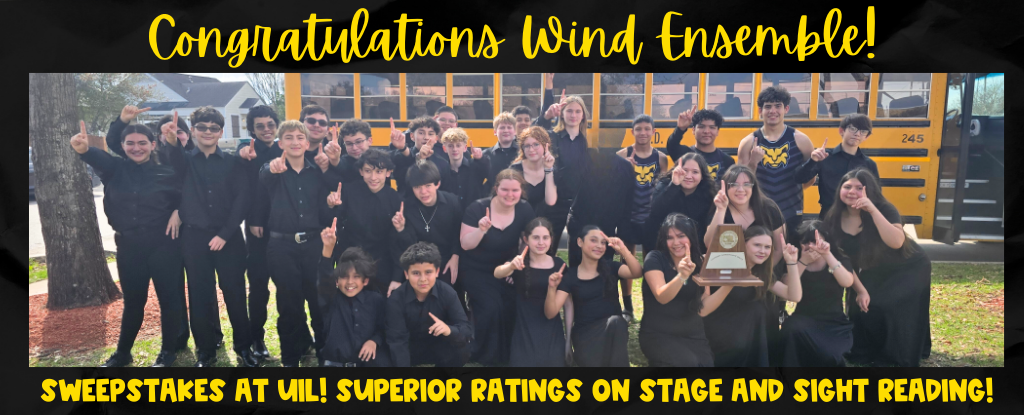 Group of musicians celebrating with a trophy in front of a school bus.