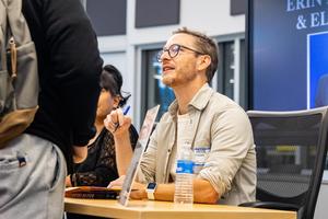 Eliot Schrefer signs a book for a student