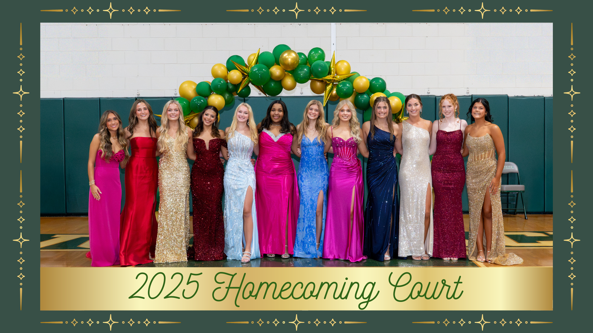 Homecoming court wearing colorful gowns stands in front of a festive archway.
