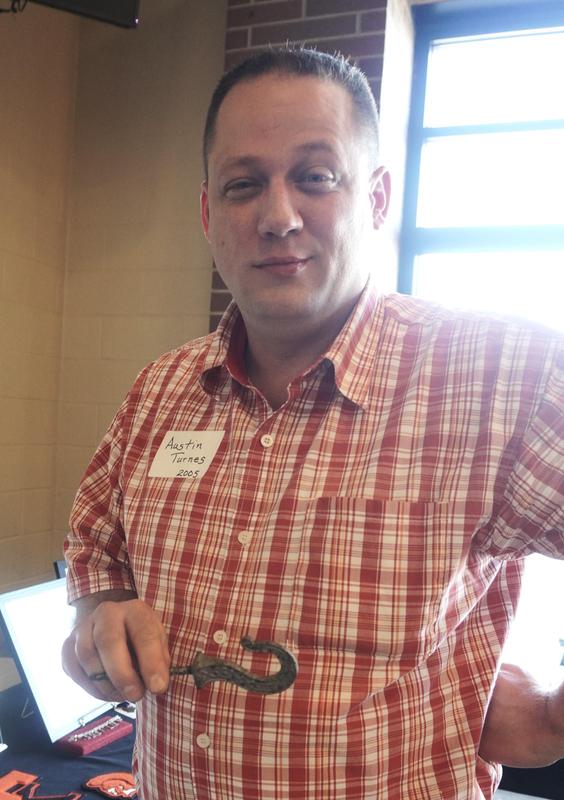 TK Alum Austin Turnes (Class of '05) explains an artifact found on school grounds.
